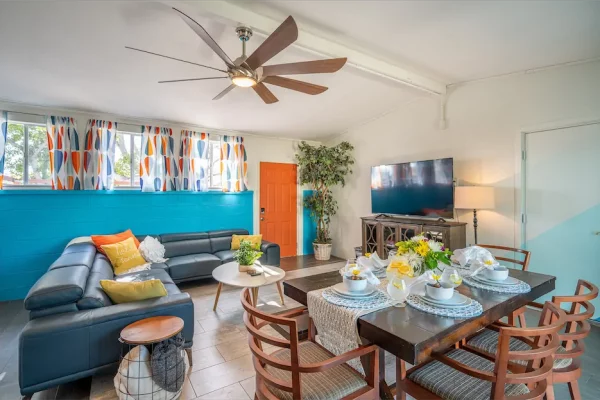 The bonus room in Hello Sunshine is a magnificent space that boasts ample room for dining and entertainment. The full-size dining table in the center of the room is a highlight of the space, with its ability to expand and seat up to eight people.