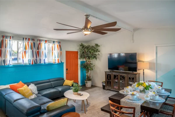 The bonus room in Hello Sunshine is a magnificent space that boasts ample room for dining and entertainment. The full-size dining table in the center of the room is a highlight of the space, with its ability to expand and seat up to eight people.